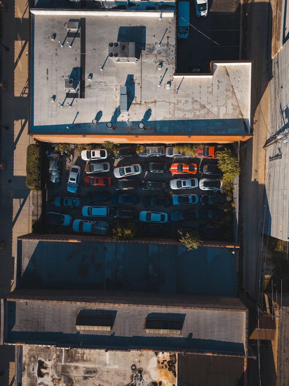 aerial view of urban parking lot with cars